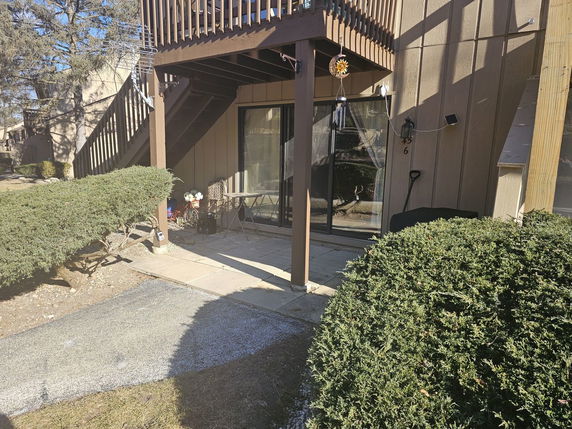 Front view of a house with patio and staircase.