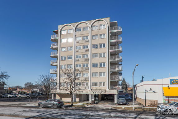 Front view of a multi-story apartment building with balconies.