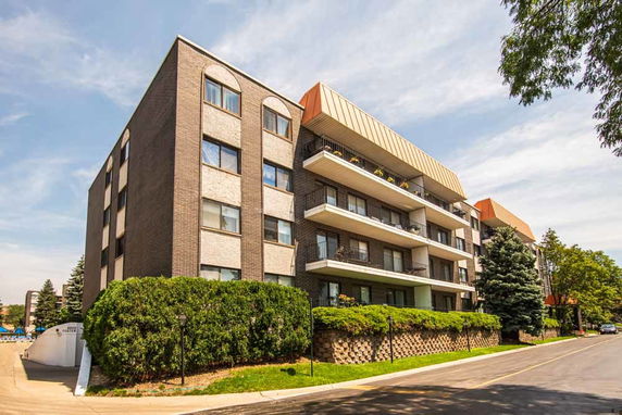 Front view of a multi-story apartment building with balconies.