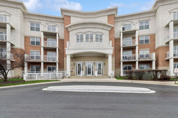 Front view of a multi-story residential building with balconies.