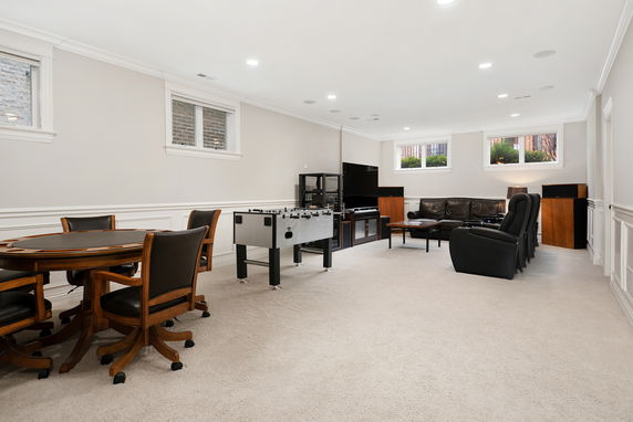 Recreation room with games table, foosball, and seating area.