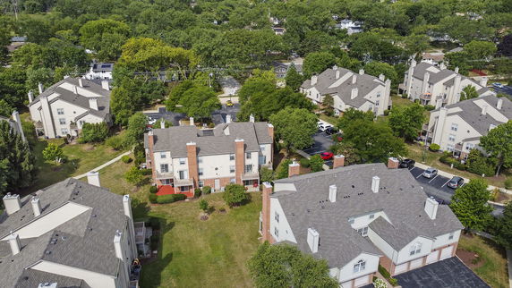 Aerial view of multiple residential buildings with surrounding greenery.