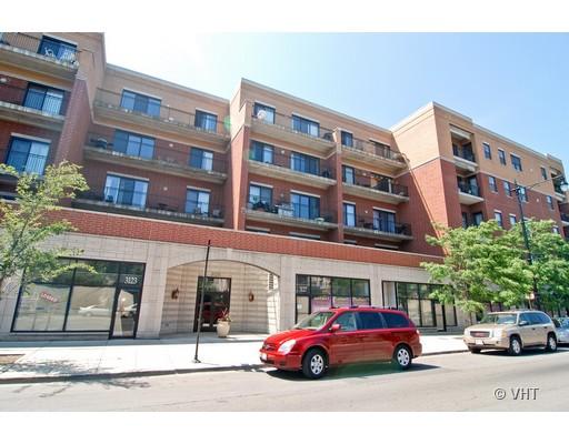 Front view of a multi-story residential building with balconies.
