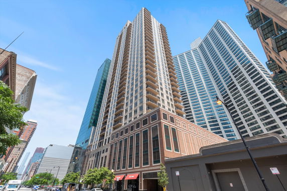Front view of a tall residential high-rise building in an urban setting.