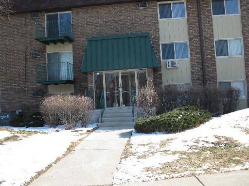 Front view of a multi-story building with a green awning above the entrance.