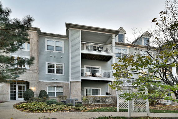 Front view of a three-story apartment building with balconies.