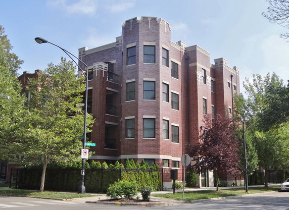 Front view of a multi-story brick apartment building.