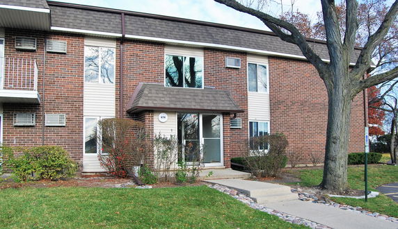 Front view of a two-story building with brick and panel siding.