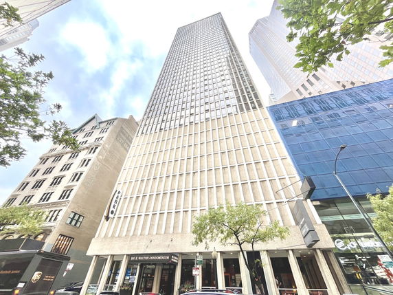 Front view of a tall commercial building with a grid-like facade.