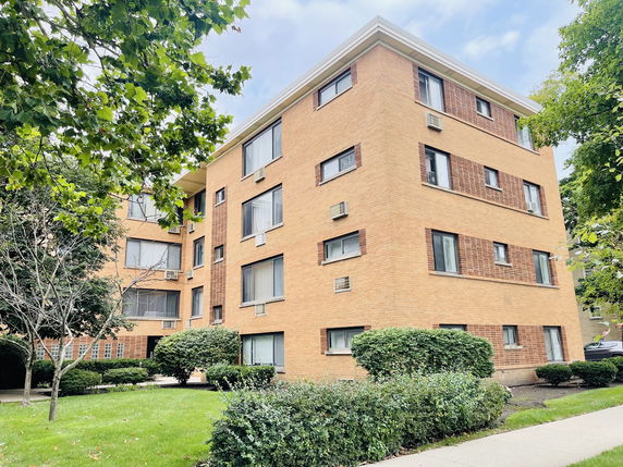 Front view of a multi-story brick apartment building