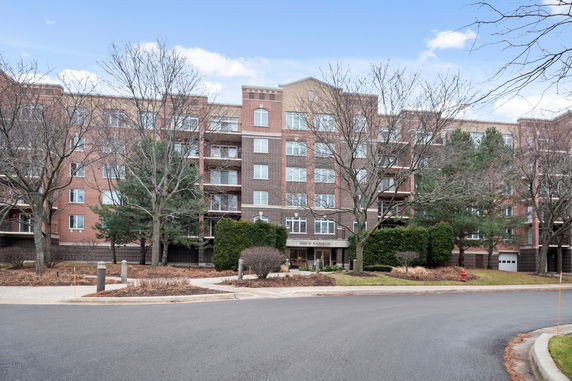 Front view of a multi-story apartment building with a brick facade.