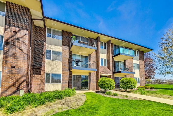 Front view of a multi-story residential building with balconies.