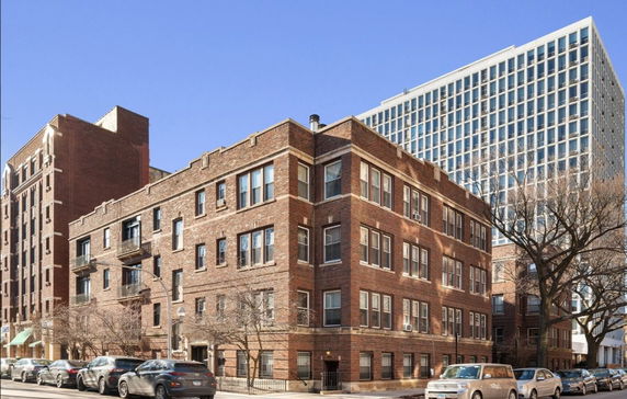 Front view of a multi-story brick apartment building.