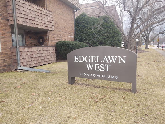 Front view of a condominium building with a sign that reads 'Edgelawn West Condominiums'.