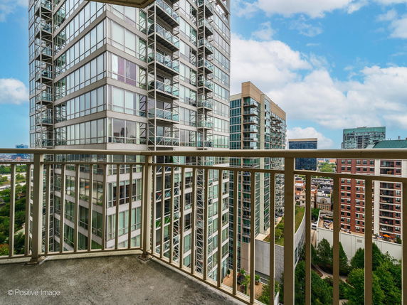 Panoramic view of cityscape from a balcony in a high-rise building.