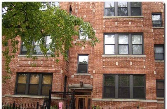 Front view of a multi-story brick apartment building.