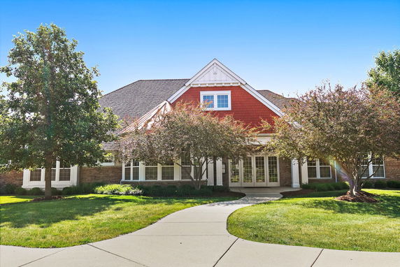 Front view of a house with a red gable and large windows.