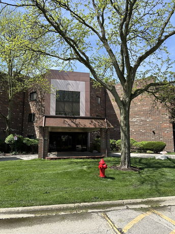 Front view of a brick building with a covered entrance.