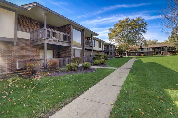 Front view of a two-story apartment building with balconies.