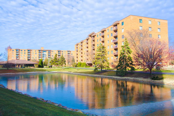 Front view of a multi-story apartment building with balconies.