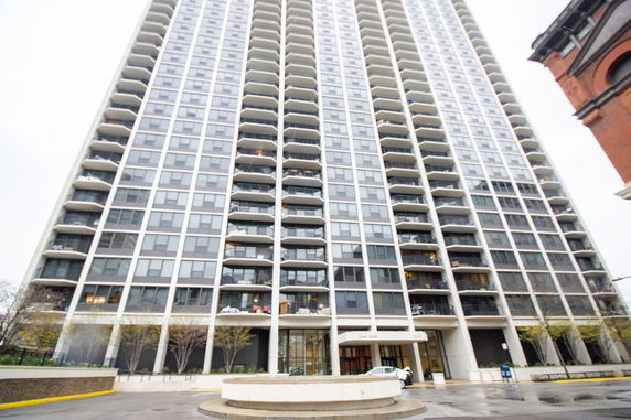 Front view of a high-rise apartment building with multiple balconies.