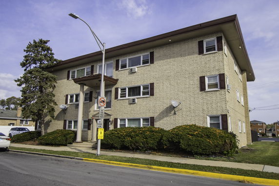 Front view of a three-story brick apartment building.