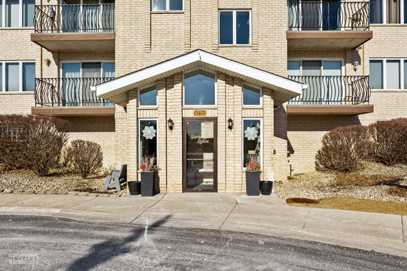 Front view of a multi-story building with balconies.