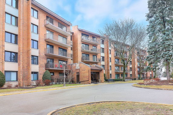 Front view of a multi-story residential building with balconies.