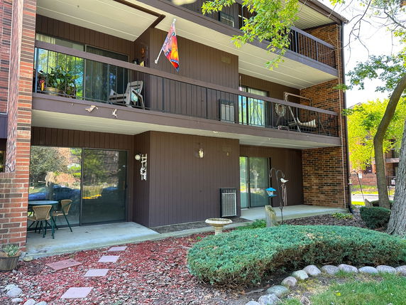 Front view of a building with multiple balconies and sliding glass doors.