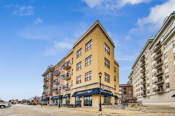 Front view of a multi-story building with ground-floor cafe.
