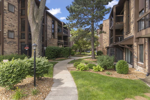 Front view of multi-story apartment buildings with brick exterior and balconies.