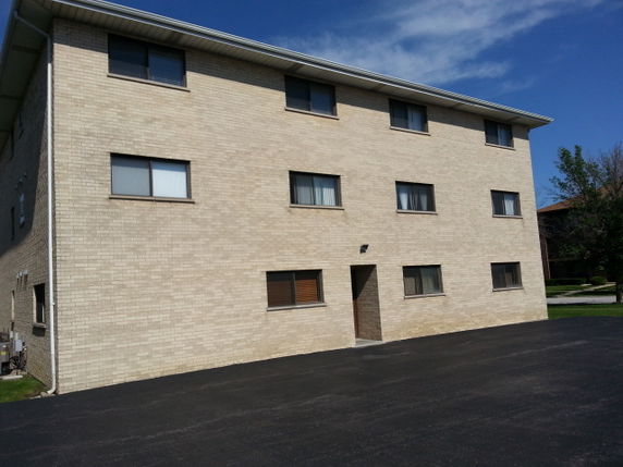 Front view of a three-story brick building.