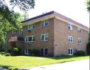 Front view of a three-story brick apartment building.