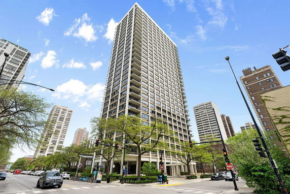 Front view of a tall high-rise building with balconies.