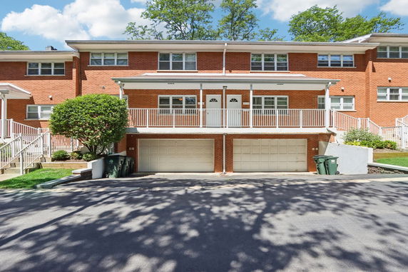 Front view of a two-story brick building with a two-door garage.