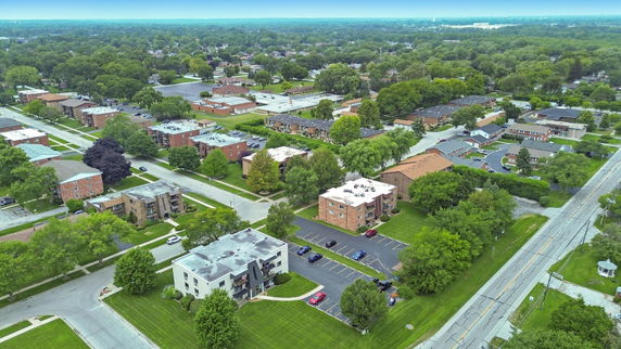 Aerial view of a suburban neighborhood with multiple residential buildings and green areas.
