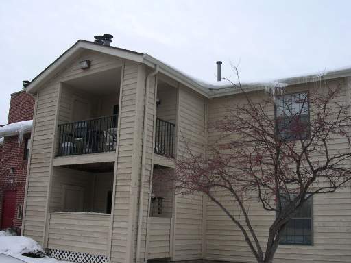 Front view of a two-story house with balconies.
