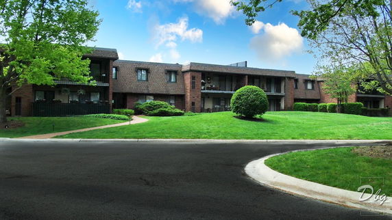 Front view of a multistory residential building with balconies.