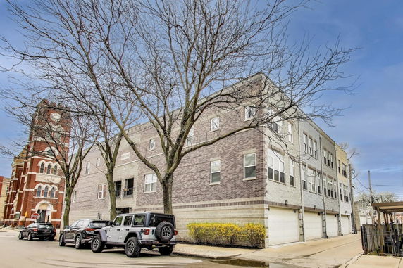 Front view of a multi-story building with garages.