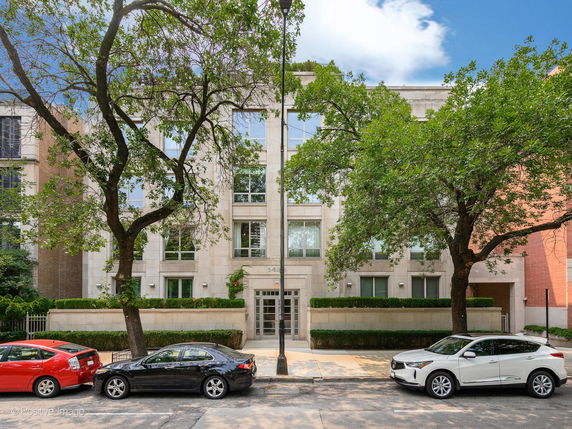 Front view of a multi-story building with symmetrical windows and a central entrance.