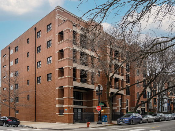 Front view of a multi-story brick apartment building.