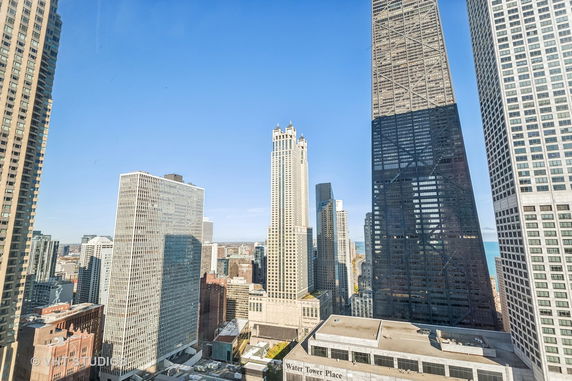 Panoramic view of city skyscrapers with a clear blue sky in the background.