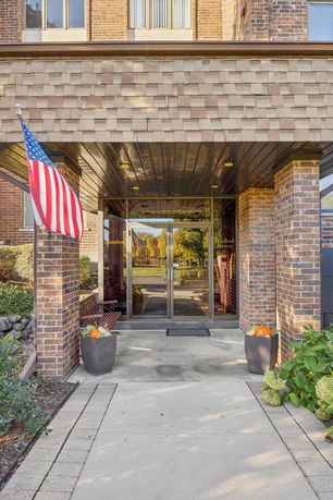 Entrance of a brick building with glass double doors.