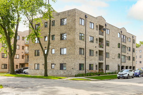 Front view of a multi-story brick apartment building.