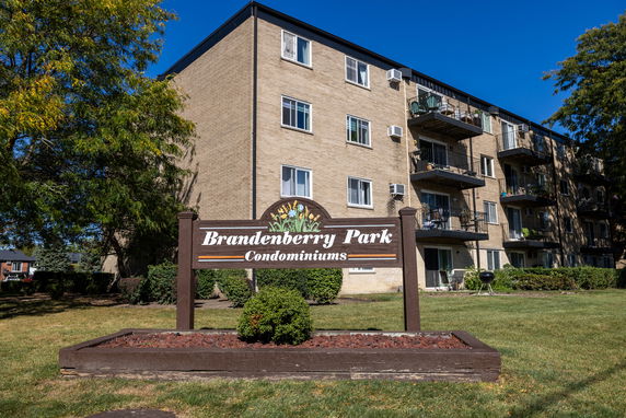 Front view of a multi-story condominium building with balconies.