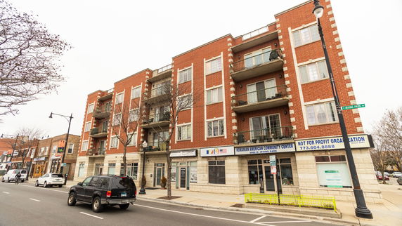 Front view of a multi-story building with a community center on the ground floor.