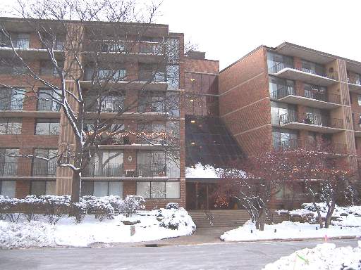 Front view of a multi-story apartment building with balconies.