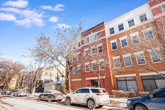 Front view of a multi-story brick apartment building.