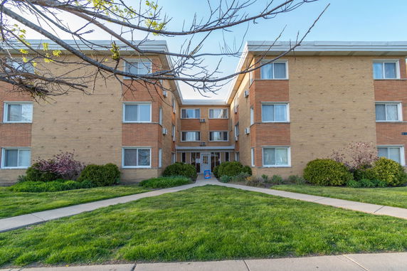 Front view of a three-story brick apartment building.