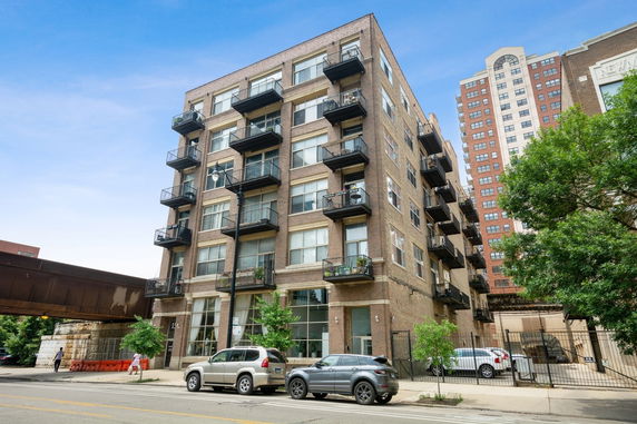 Front view of a multi-story apartment building with balconies.